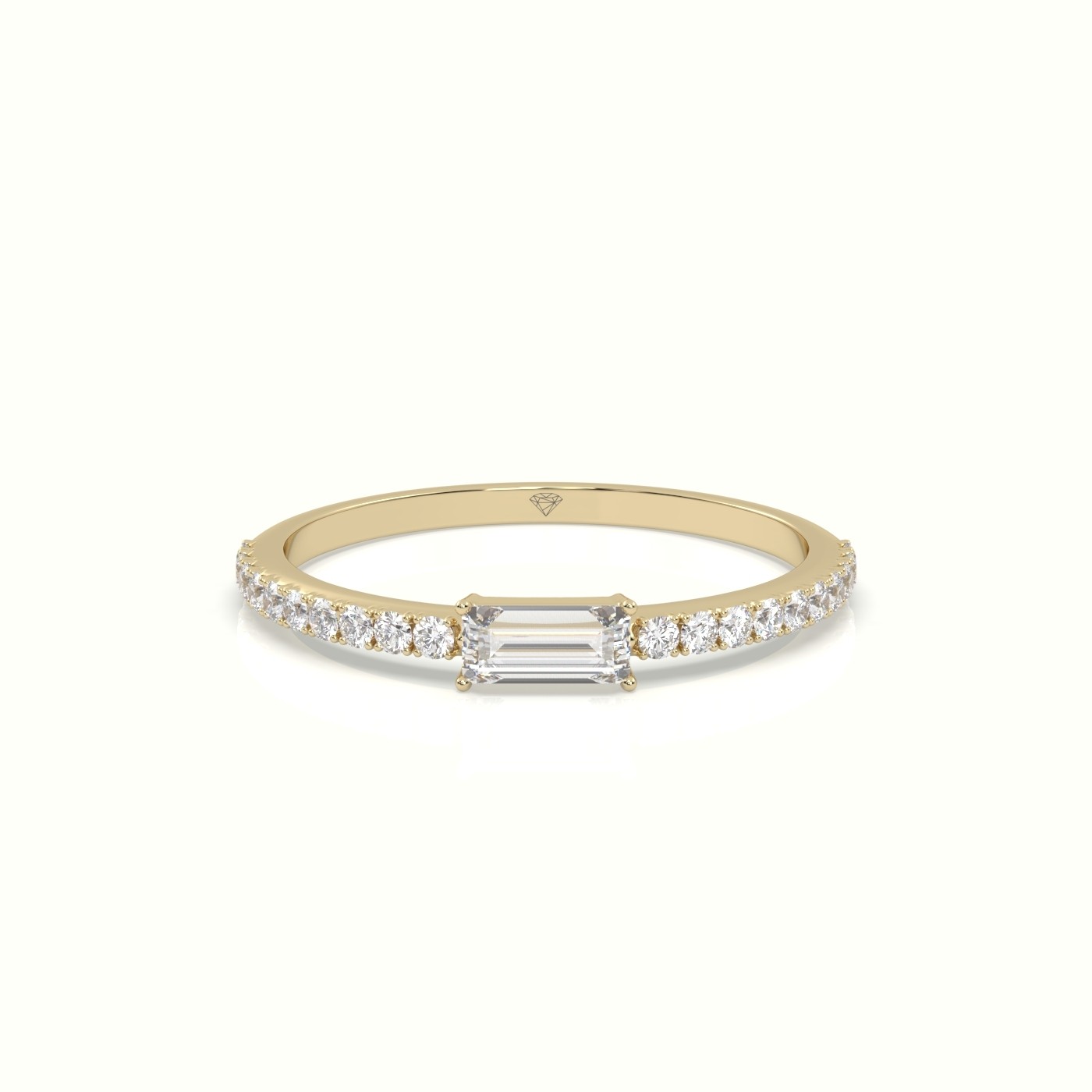18k yellow gold diamond ring with baguette diamond center stone and round cut diamonds